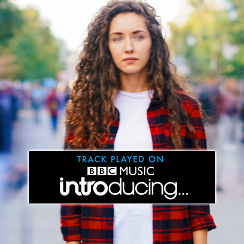 woman stands in front of blur of people